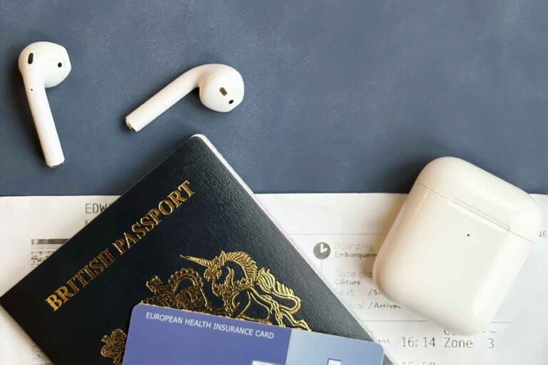 ear pods, passport and plane tiicket representing ear care when travelling abroad